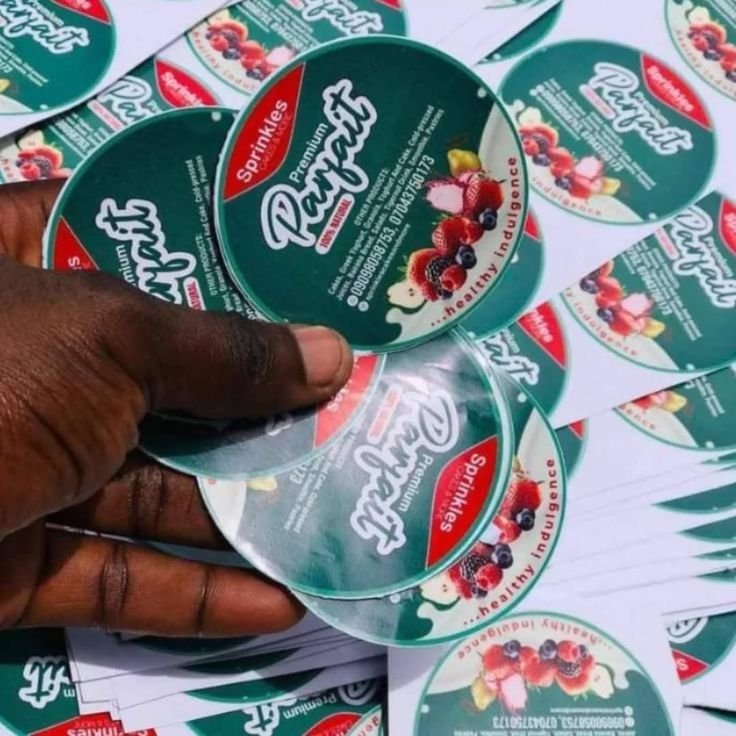 Premium PET label printing — colourful round labels held in hand